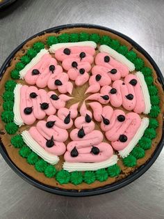 a cake decorated with pink and green frosting