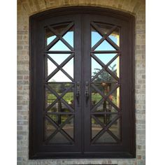 an image of a double door with glass on the outside and brick wall behind it