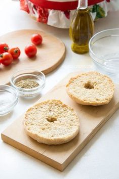 two bagels sitting on top of a cutting board