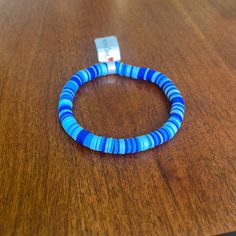 a wooden table with a blue bracelet on it