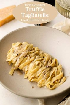 a white plate topped with pasta covered in sauce