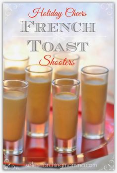 four shot glasses filled with orange juice on top of a red tray and the words holiday cheers french toast shooters