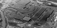 an aerial view of a large industrial area with many buildings and water in the foreground