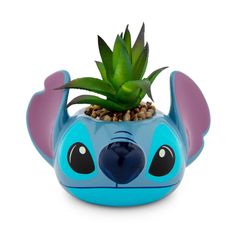 a small potted plant in the shape of a disney character's face with ears