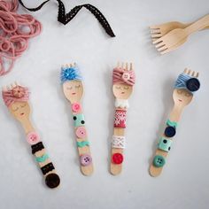 four wooden hairbrushes with different designs and buttons on them, sitting next to each other