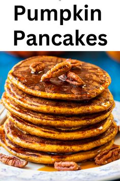 stack of pumpkin pancakes on a plate with pecans