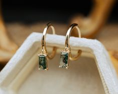 These delicate earrings are crafted with meticulous attention to detail. The focal point is the mesmerizing moss agate gemstones, each possessing a unique landscape of moss-like inclusions reminiscent of a miniature forest captured in stone. The moss agate stones, polished to a gentle sheen, exude a serene, organic beauty, with hues ranging from deep greens to translucent whites, evoking the tranquil essence of nature. Whether worn for a special occasion or to add a touch of elegance to everyday Moss Agate Earrings, Miniature Forest, Moss Agate Jewelry, Earring Stack, Staghead Designs, Antique Gift, Agate Earrings, Custom Ring Designs, Agate Necklace