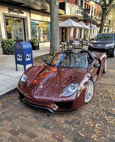 a red sports car parked on the side of a street