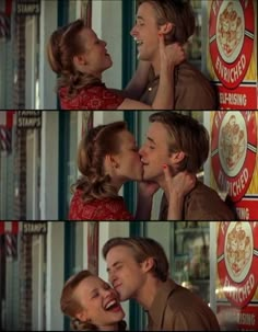 a man and woman kissing each other in front of a storefront with signs on it