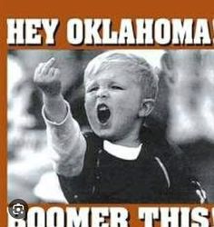 a young boy is screaming while holding his hand up in the air and saying hey oklahoma boomer this