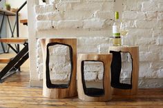 three pieces of art made out of wood with wine bottle in the top and bottom