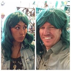 a man and woman with green hair posing for the camera, one is wearing a denim jacket