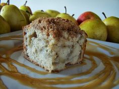 a piece of cake sitting on top of a white plate next to some pears