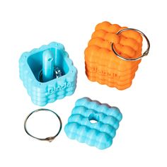 three different types of ring holders and keychains on a white background, including one with an inflatable ball attached to it