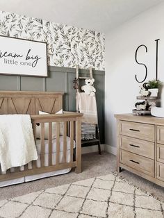 a baby's room with a crib and dresser