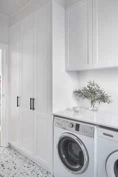 a washer and dryer in a white laundry room