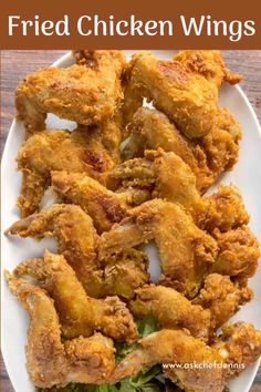 fried chicken wings on a white plate with lettuce