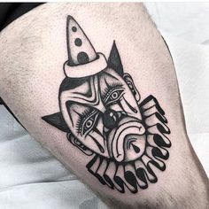 a man's leg with a black and white tattoo design on the side of his thigh