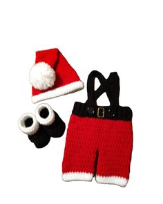 a crocheted hat, mittens and booties are set on a white background