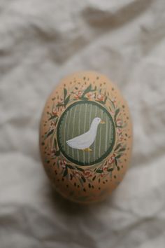 an egg with a white bird painted on it