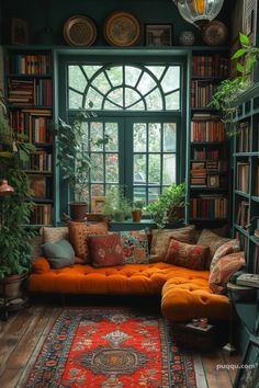 a living room filled with lots of books and furniture next to a large green window