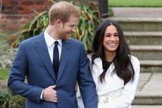 prince harry and his wife, the duke of cambridge smile as they walk down steps