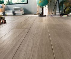 a room with wood floors and a globe on the floor