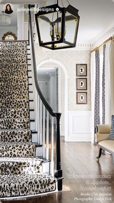 a leopard print carpeted stair case in a home with white walls and wood floors