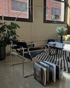 a black and white checkered floor in a living room next to a large window