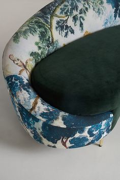 an upholstered chair with a green cushion