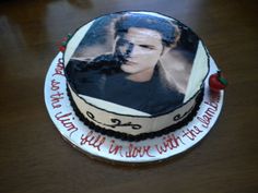 a birthday cake with an image of elvis presley on the side and writing in red