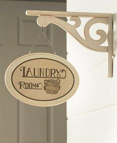 a wooden sign hanging from the side of a door