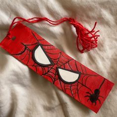 a red piece of paper with spiderman's eyes on it