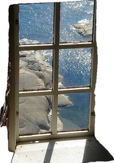 an open window looking out at the ocean