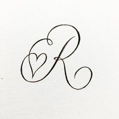 the letter k with two hearts drawn on it's back and bottom corner, in black ink