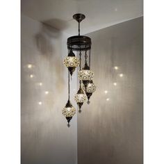 a chandelier hanging from the ceiling in a room with white walls and lights