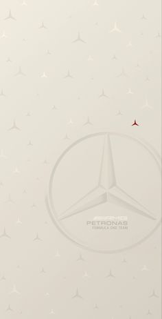 the mercedes logo is shown on a white background with small stars in the sky above it