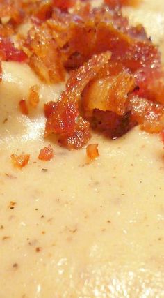 a bowl of soup with bacon and cheese on top