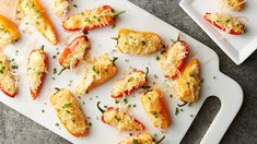 several stuffed peppers are on a cutting board