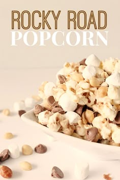 rocky road popcorn with marshmallows and peanuts in a white bowl on a table