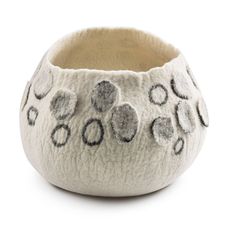 a white bowl with black and grey designs on the inside, sitting in front of a white background