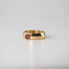 Minimalist Gold Solitaire Ruby Ring, Gift Dome Ring With Solitaire In Round Band, Minimalist Gold Ruby Ring With Bezel Setting, Solitaire Dome Ring With Round Band As Gift, Solitaire Dome Ring With Round Band, Modern Ruby Birthstone Ring, Minimalist Gold Ruby Ring For Formal Occasions, Thick Band Ring, Ruby Solitaire Ring