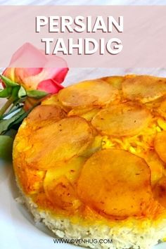 a close up of a pie on a plate with rice and flowers in the background