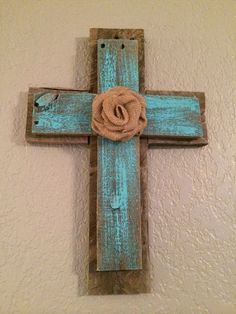 a wooden cross with a rose on it