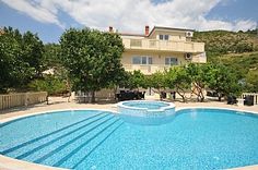 an empty swimming pool in front of a house