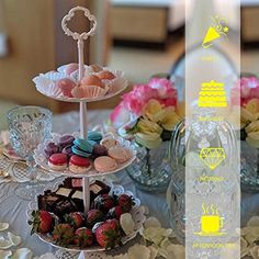 a table topped with three tiered trays filled with cakes and cupcakes