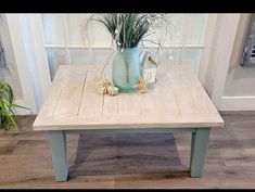 a wooden table with a blue vase on top