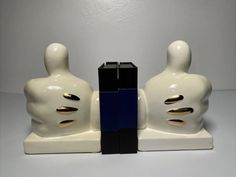 two white and black sculptures sitting next to each other