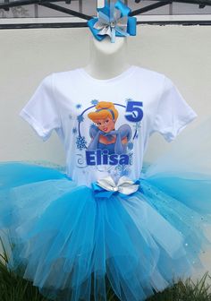 a white shirt and blue tutu skirt on display