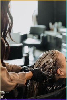 a woman getting her hair cut at a salon